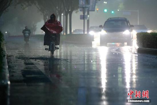 北京市民在雨中前行。 <a target='_blank' href='http://www.chinanews.com/'>中新社</a>記者 劉關(guān)關(guān) 攝