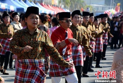 踩街隊伍在美食街上穿行表演，整個活動現(xiàn)場成為歌舞的海洋。　張金川　攝