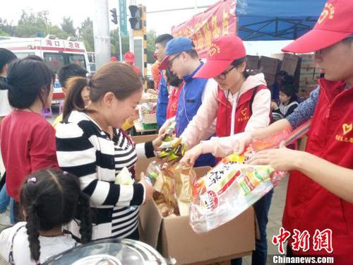 2月21日，海口新海港附近，志愿者為旅客發(fā)放食物?！∫Ｃ?攝